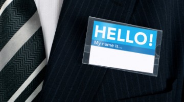 Namebadge saying hello on a well dressed businessman - insert your own information