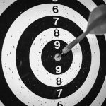 A picture of a target with a dart stuck in the bullseye, showing how important finding your target audience is for Darren and Mike.