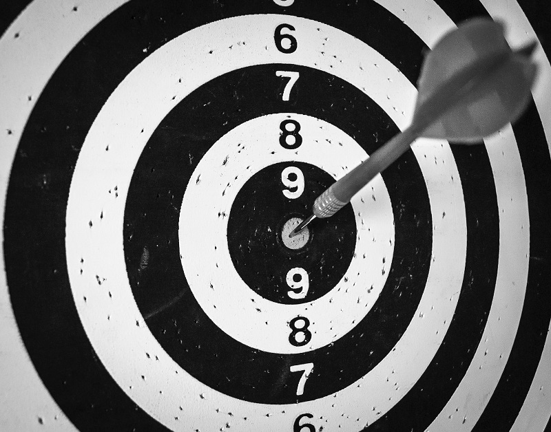A picture of a target with a dart stuck in the bullseye, showing how important finding your target audience is for Darren and Mike.